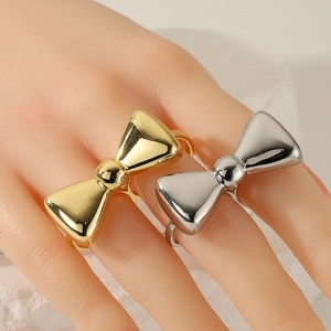 Exaggerated fashion gold and silver bow rings set on model for daily style