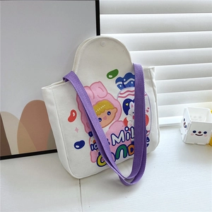 Detail of canvas tote bag featuring purple straps and colorful cartoon girl printing