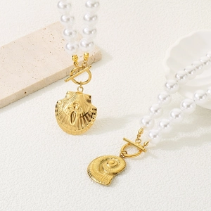 Detail of vintage pearl chain with gold seashell pendants and OT toggle clasp closure