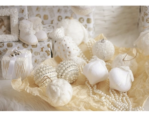 Detailed close-up of white velvet Christmas ornaments with pearls and gold sequins decor