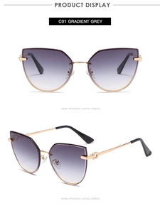 Detail view of cat-eye sunglasses with gradient grey lenses and golden metal temples