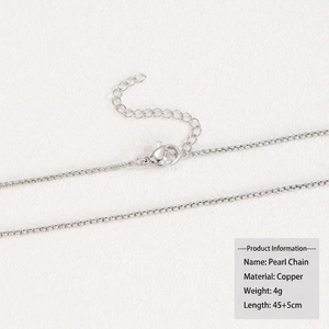 Detail of silver-plated copper cross chain with lobster clasp and extension link
