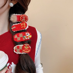 Detail of red New Year hair clips with embroidery, lace edges, and plush horse charms
