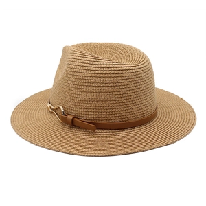 Detail of light khaki straw hat featuring a brown leather band and gold metal horsebit buckle