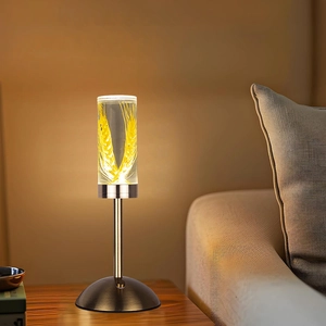 Detail of warm LED night light with wheat ear pattern and brass base on nightstand