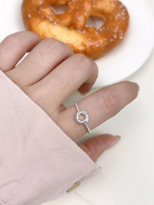 Detail of s925 silver textured ring on finger with a minimalist bread aesthetic design
