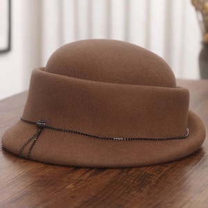 Detail of dark brown wool felt hat featuring sparkling bead chain and fringe accents