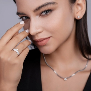 Elegant S925 sterling silver V-shape moissanite ring set worn by model in a fashion scene