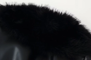 Gros plan détaillé du col en fausse fourrure noire cousu sur une veste en cuir de qualité