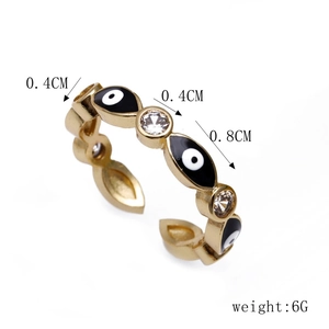 Detail view of gold evil eye open ring with zircon inlay and enamel craft details