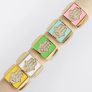 Macro shot of colorful enamel square rings with micro-set zircon Hamsa Hand charms