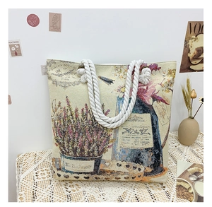 Close-up of vintage floral jacquard tote bag with white cotton rope handles and Paris text