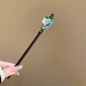 Detail of wooden hair stick with gold phoenix enamel, green jade beads and shell flower