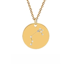 Detailed view of a gold 12 constellations pendant necklace with inlaid zircon accents