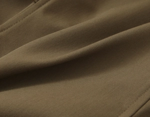 Close-up of premium brown twill fabric texture with intricate diagonal weave patterns