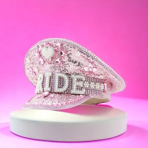 Detailed view of pink sequins and BRIDE lettering with heart pearl ornament on hat