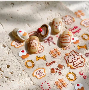 Detail of cute dog nail stickers with 3D texture and cartoon bone patterns on stone