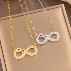 Detail of gold and silver infinity heart necklaces with shimmering crystal accents