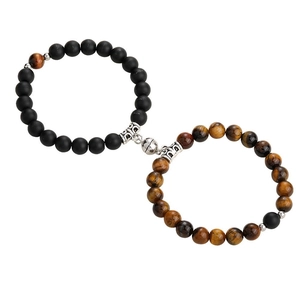 Magnetic couples bracelets with matte black agate and tiger eye beads on white background