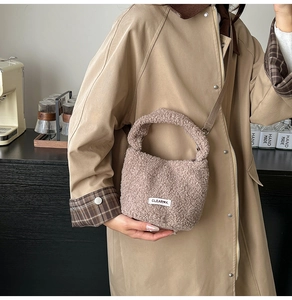Detail of pink plush bucket bag featuring soft faux shearling texture and CLEAR logo tag