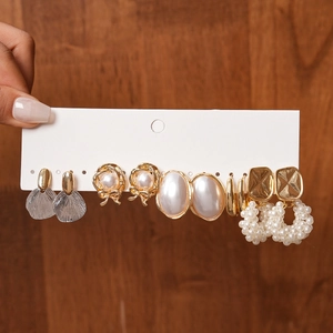 Set of six gold and pearl earrings including studs and hoops on display card