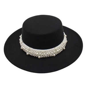 Detail of elegant black wool felt boater hat featuring luxury white pearl cluster band