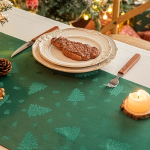 Green Christmas tree jacquard table runner with festive holiday decor and candles