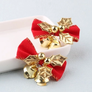 Red Christmas bow decorations with gold bells and leaves for festive holiday ornaments