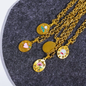 Detailed view of gold oval charms with rose and love motifs on box chain necklaces