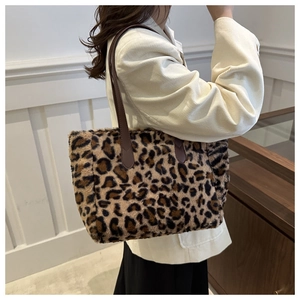 Detailed view of leopard print plush tote bag showing thick faux fur texture and handle