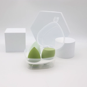 Three gradient green makeup sponges set in a clear heart-shaped box for makeup application