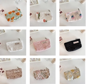 Collage of floral relief makeup bags with various vintage patterns and zipper closures