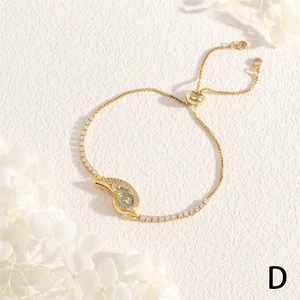 Detail of adjustable gold shell bracelet with blue enamel and micro-pave zircons