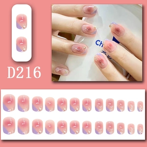 Detail of pink-purple gradient press-on nails with shell flakes and gold foil accents
