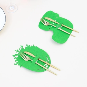 Close-up of green felt bunny and egg shaped cutlery holders with gold silverware