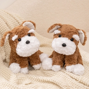 Two realistic Schnauzer plush dogs in brown and white fur on a soft knitted blanket