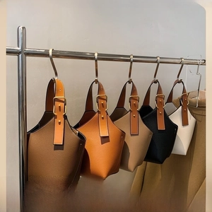 Close-up of lychee grain leather bucket bags in five colors with adjustable golden buckles