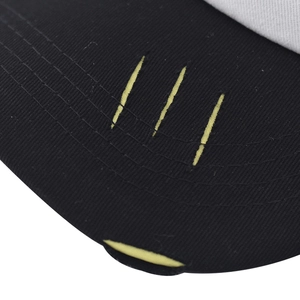 Detail of baseball cap brim featuring yellow 3D scratch embroidery and edge piping