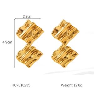 Detail showing 18K gold geometric textured earrings with dimensions 2.7cm by 4.9cm