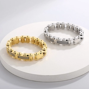 Macro detail of industrial style bike chain bracelets in gold and silver finishes