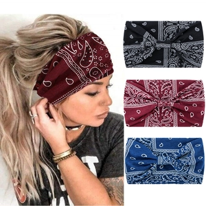 Detail of wide paisley print headbands in black, burgundy, and navy blue fabric