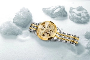 Detailed close-up of hollow skeleton mechanical watch with golden geometric bezel