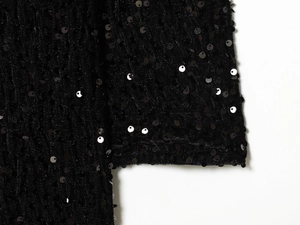 Close-up of black sequins on premium velvet fabric of this elegant mini party dress