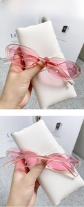 Detail of pink transparent cat-eye sunglasses with lightweight resin frames