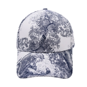 Detail of white canvas baseball cap featuring blue Toile de Jouy animal print pattern