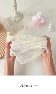 Detailed texture of white pearlescent wrapping paper with soft folds and high quality finish
