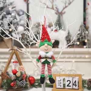 Christmas elf ornament with red sequin hat and striped legs hanging on tree branch