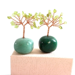Detailed view of handmade green crystal money trees with twisted copper wire on round base