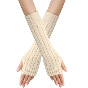 Detailed knit texture of beige cable-knit arm warmers with thumb holes and open fingers