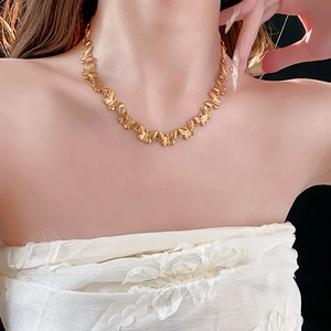 Elegant gold titanium steel necklace featuring a continuous butterfly design on a model